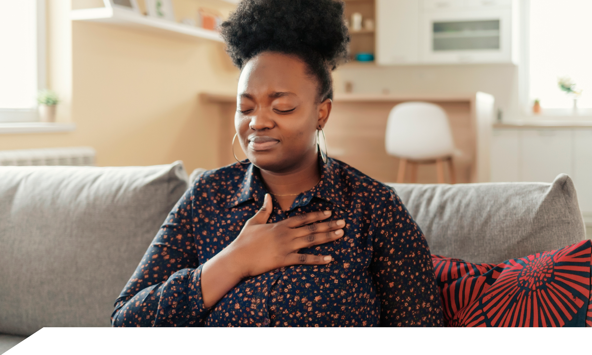 A woman with her hand on her chest looking uncomfortable