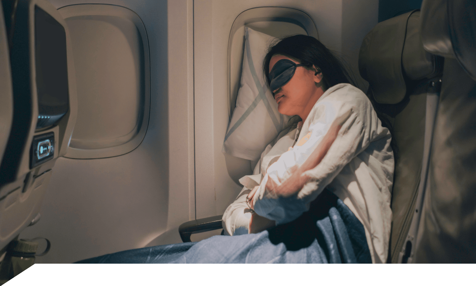 A woman sleeping on a plane