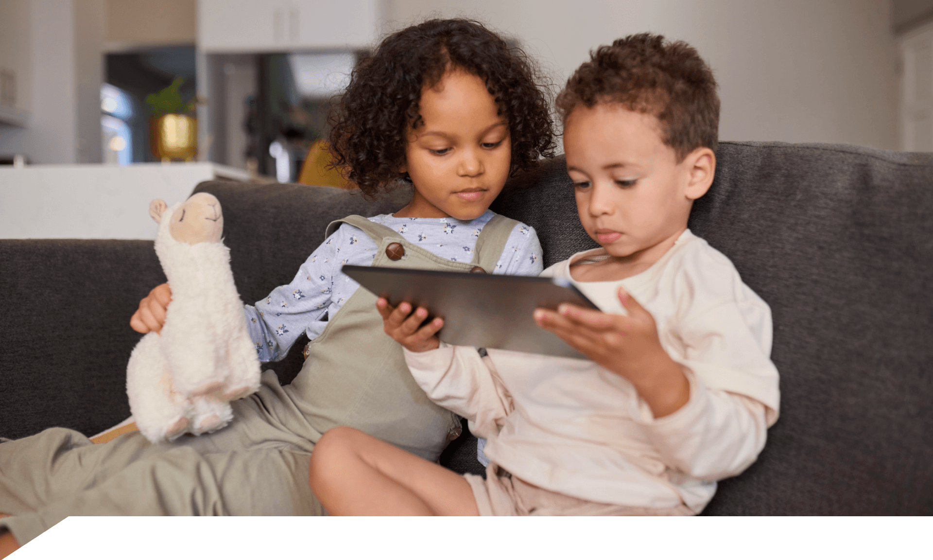 two kids looking at ipad