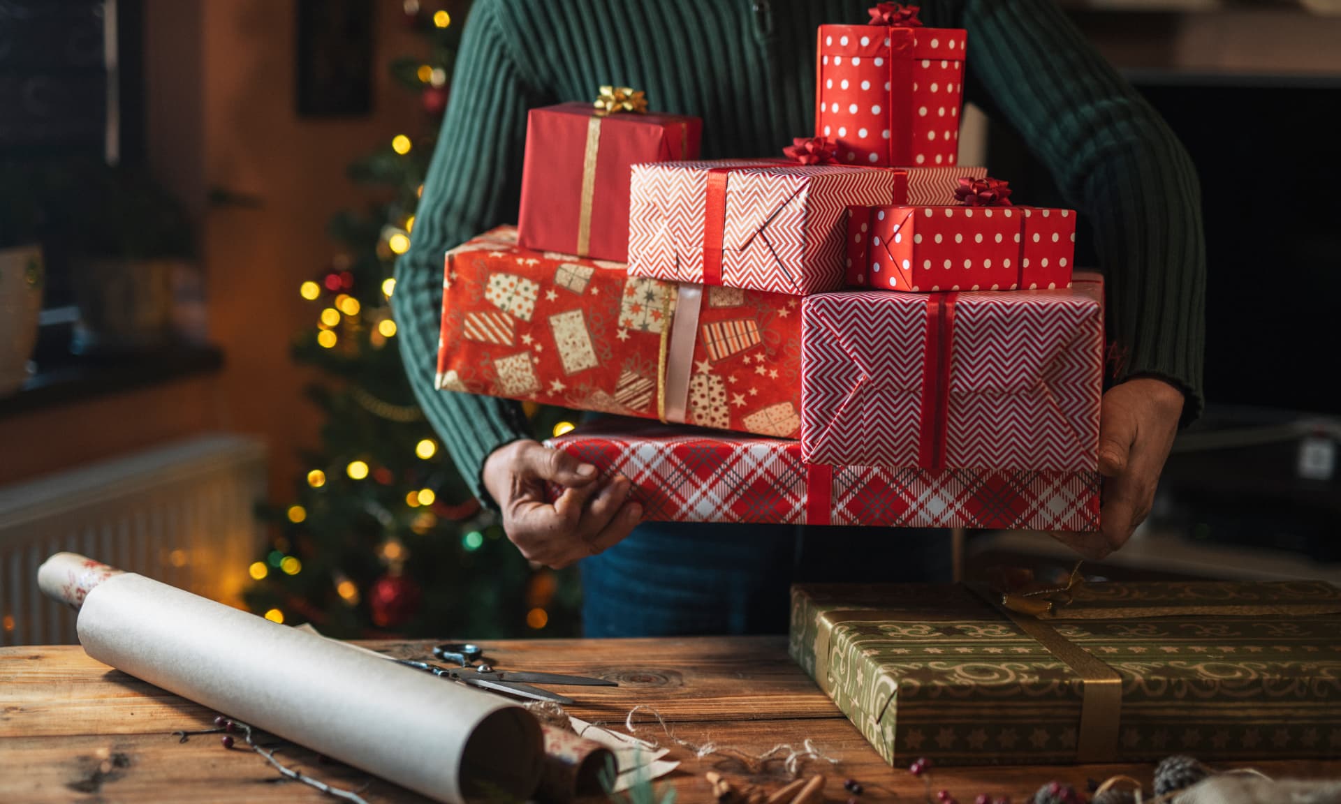 A woman holding a pile of gifts.