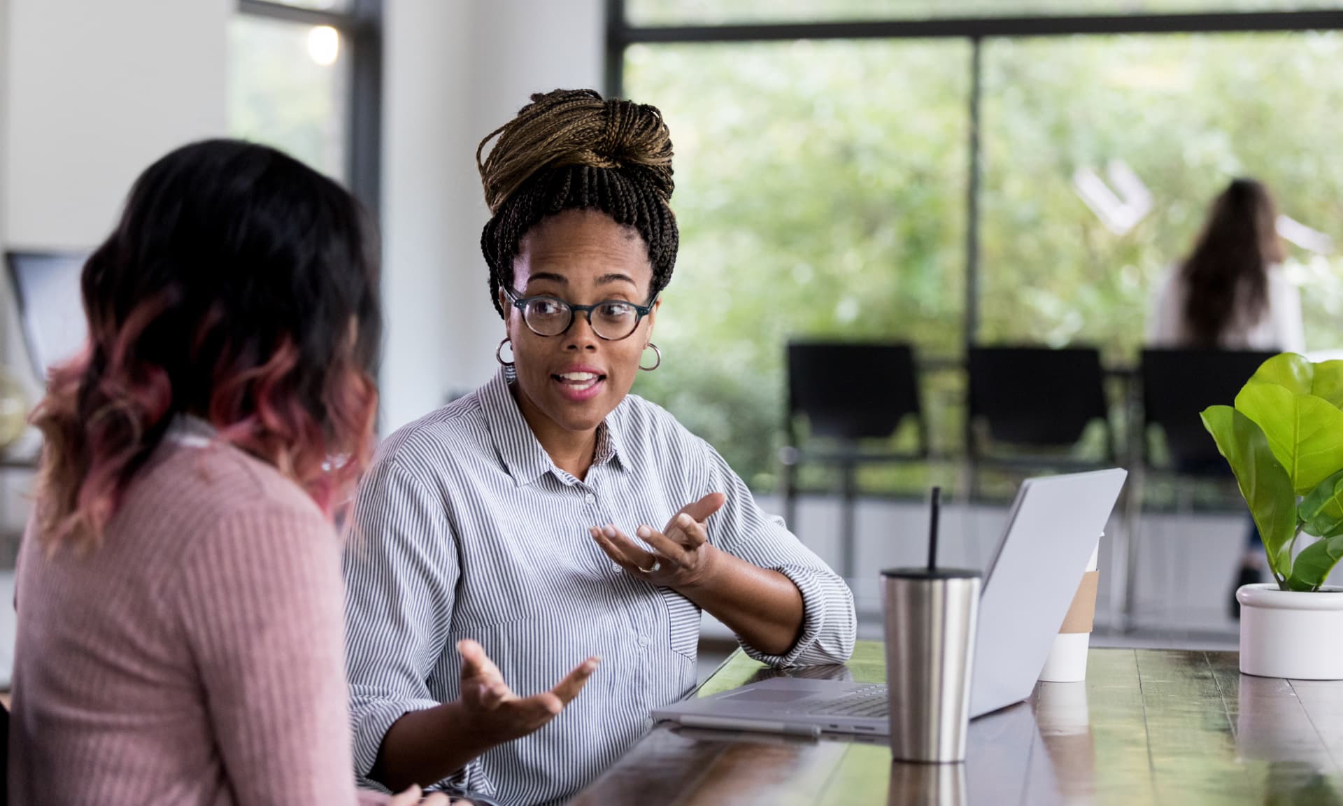 Two women talking at work.