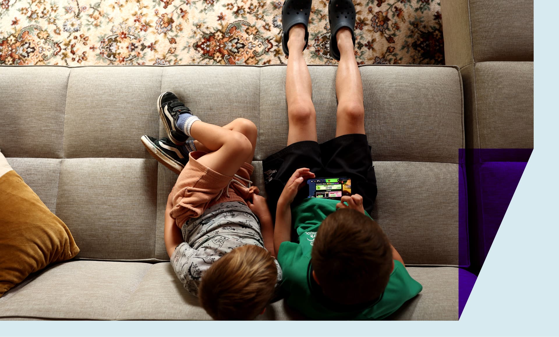 In this photo illustration, young children hold an iPhone while using the online game platform Roblox