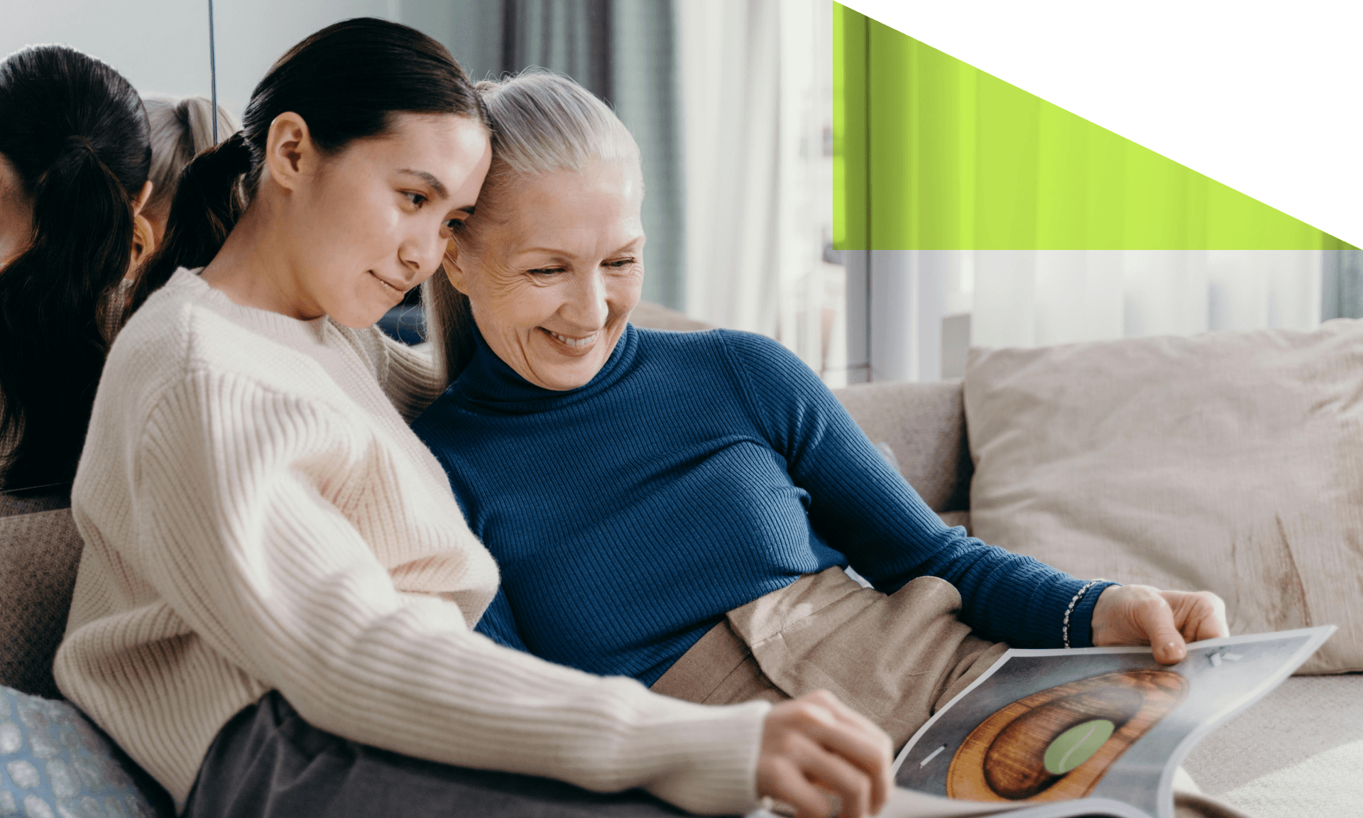 A young woman and older woman on a couch together